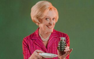 Woman holding a grenade like a teacup – Ripcord State Theatre Company